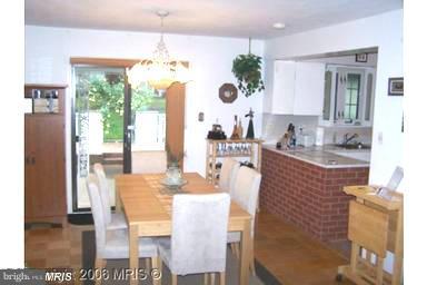 7422 Chatham Street Springfield, VA 22151 - Photo 15 of 30 a dining room with furniture a chandelier and window