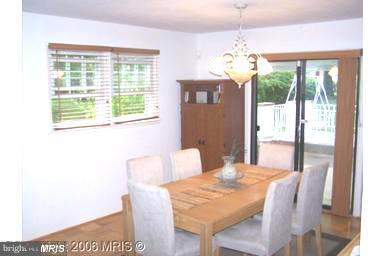 7422 Chatham Street Springfield, VA 22151 - Photo 16 of 30 a view of a dining room with furniture a chandelier and wooden floor