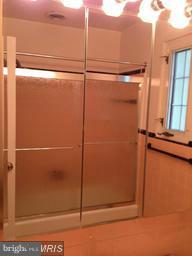 7422 Chatham Street Springfield, VA 22151 - Photo 23 of 30 a bathroom with a glass shower door