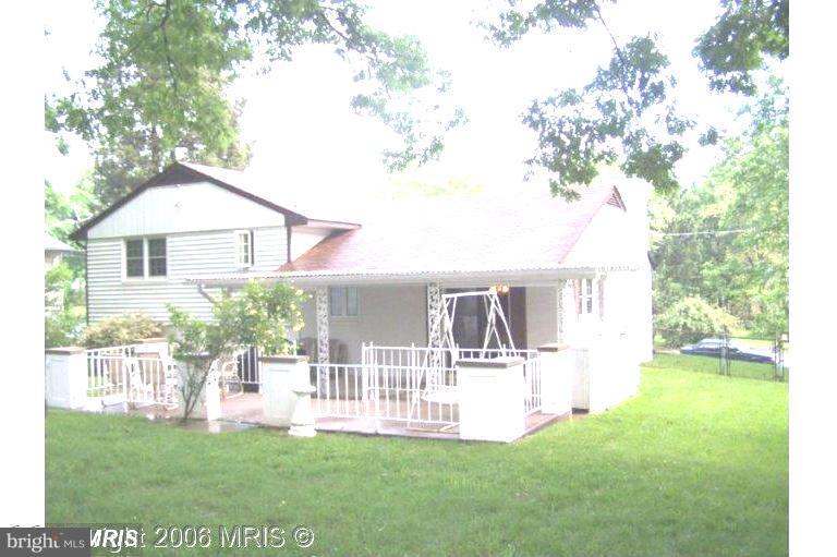 7422 Chatham Street Springfield, VA 22151 - Photo 26 of 30 a view of house with backyard and a garden