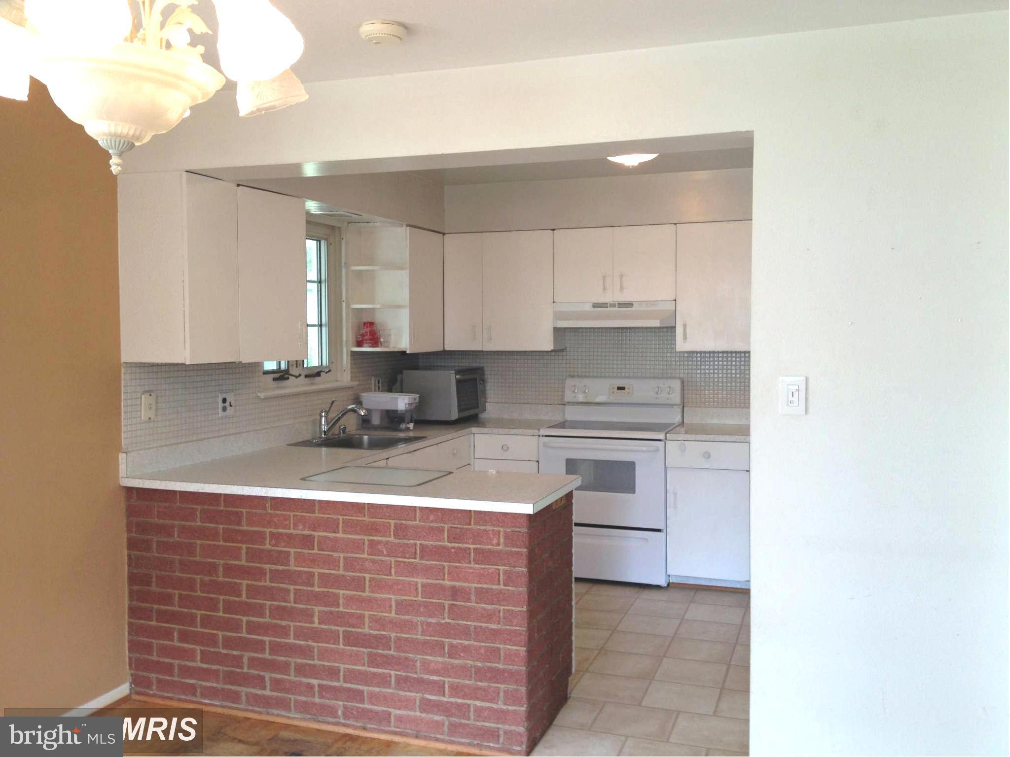 7422 Chatham Street Springfield, VA 22151 - Photo 10 of 30 a kitchen with stainless steel appliances granite countertop a sink window and cabinets