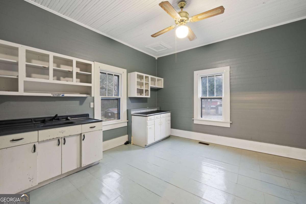 3852 New MacLand Road Powder Springs, GA 30127 - Photo 11 of 23 a kitchen with stainless steel appliances a stove a sink and a refrigerator