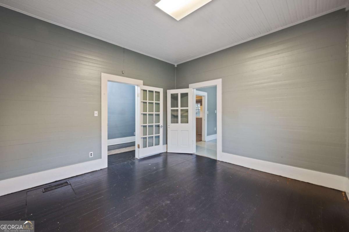 3852 New MacLand Road Powder Springs, GA 30127 - Photo 12 of 23 a view of an empty room with wooden floor
