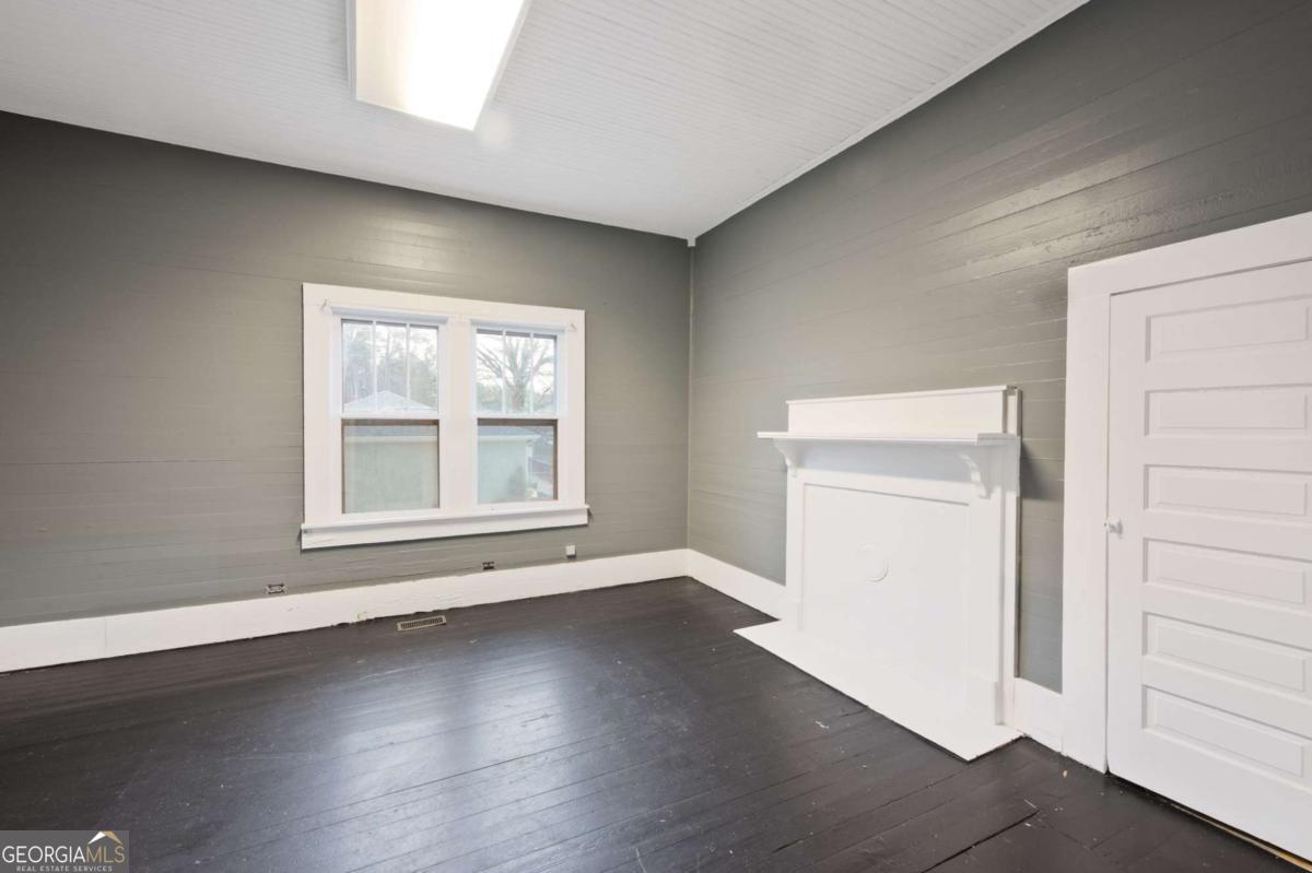 3852 New MacLand Road Powder Springs, GA 30127 - Photo 13 of 23 an empty room with wooden floor and windows