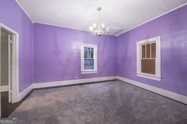 a view of empty room with chandelier