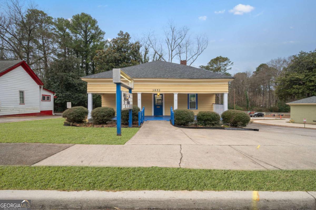 3852 New MacLand Road Powder Springs, GA 30127 - Photo 2 of 23 a front view of a house with a yard and garage