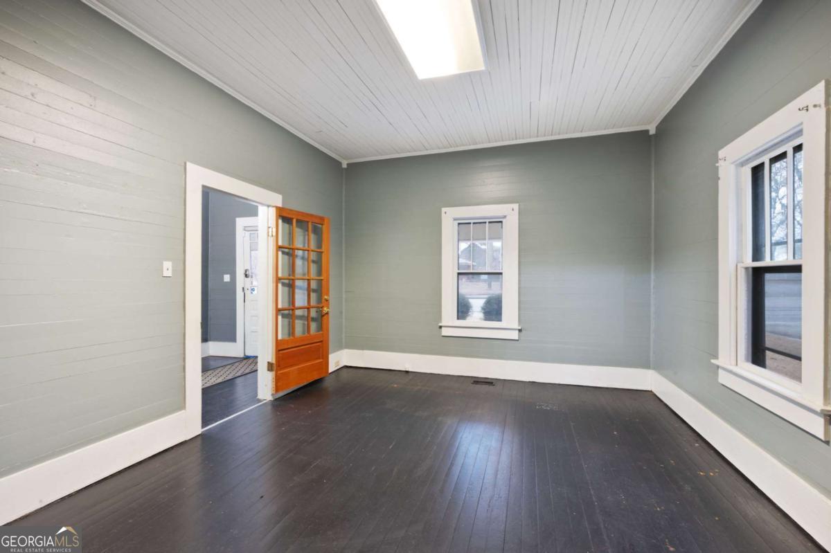 3852 New MacLand Road Powder Springs, GA 30127 - Photo 21 of 23 an empty room with wooden floor and windows