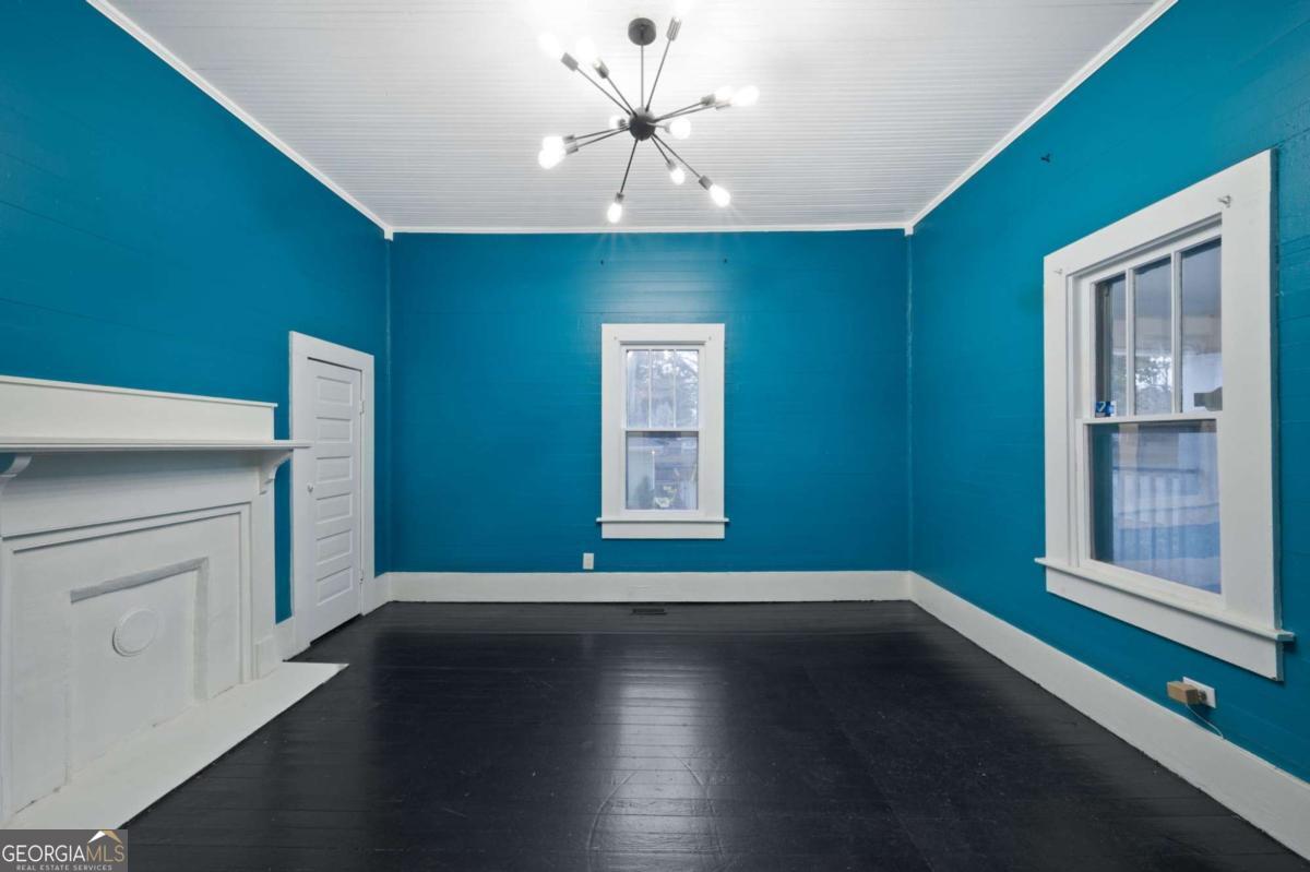 3852 New MacLand Road Powder Springs, GA 30127 - Photo 6 of 23 a view of empty room with wooden floor and fan