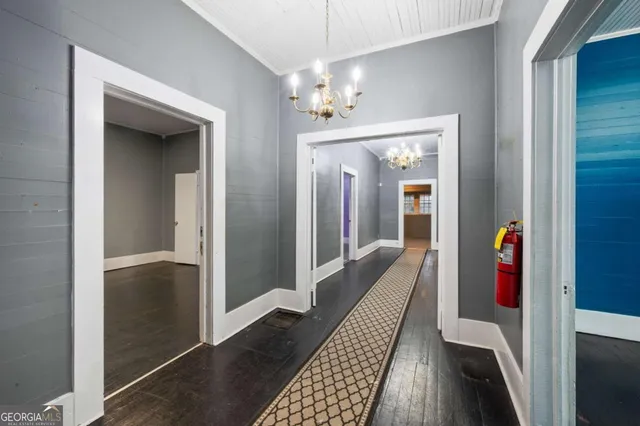 a view of a hallway view with wooden floor and staircase