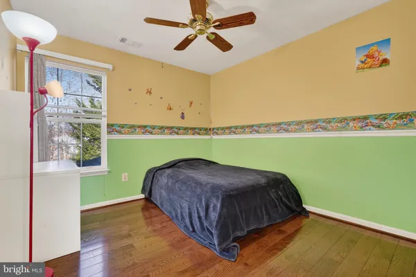 a bedroom with a bed and a painting on the wall