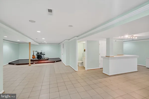 a view of a room with gym equipment and a mirror