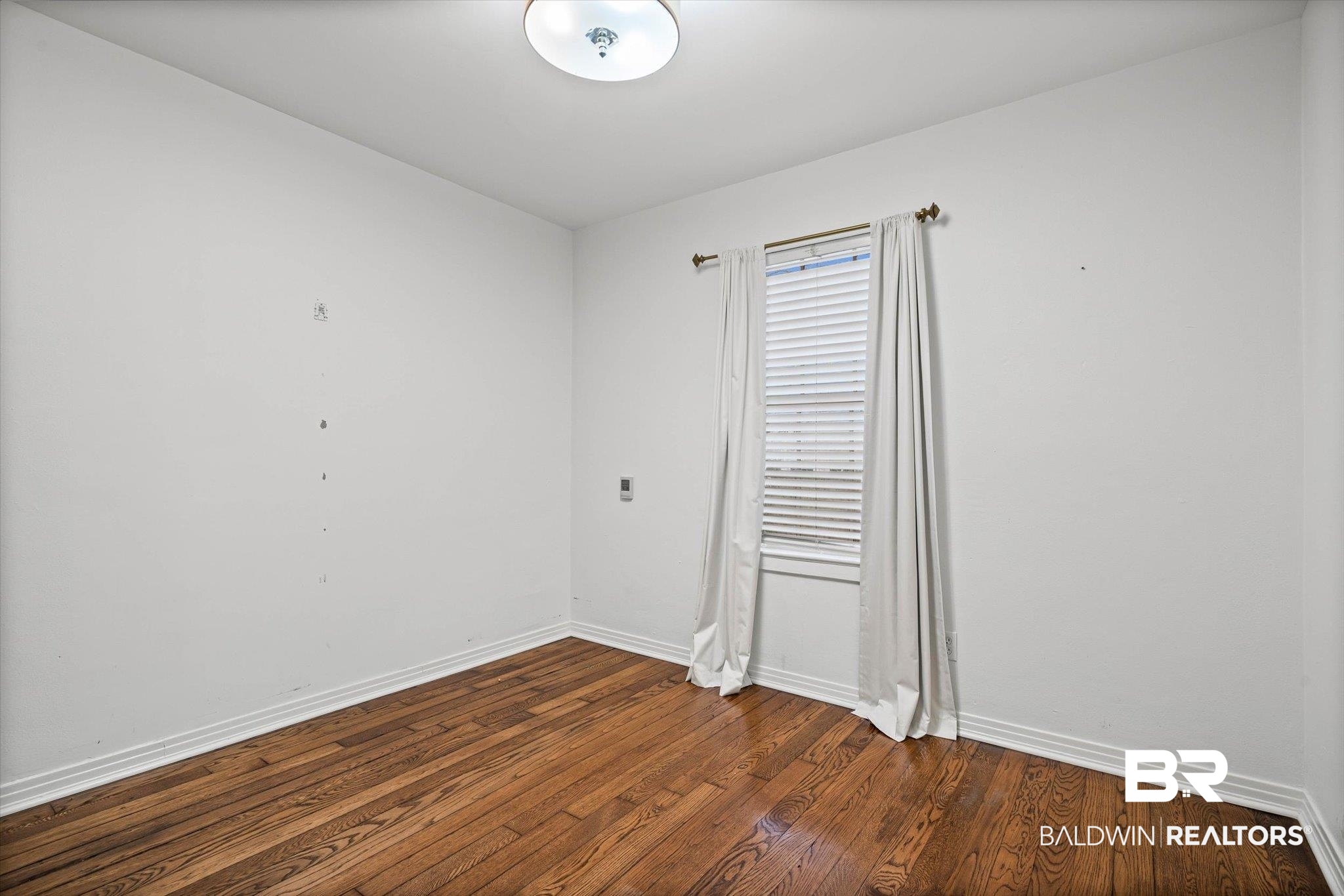 11 York Place Mobile, AL 36608 - Photo 16 of 24 Empty room with baseboards and dark wood-style floors