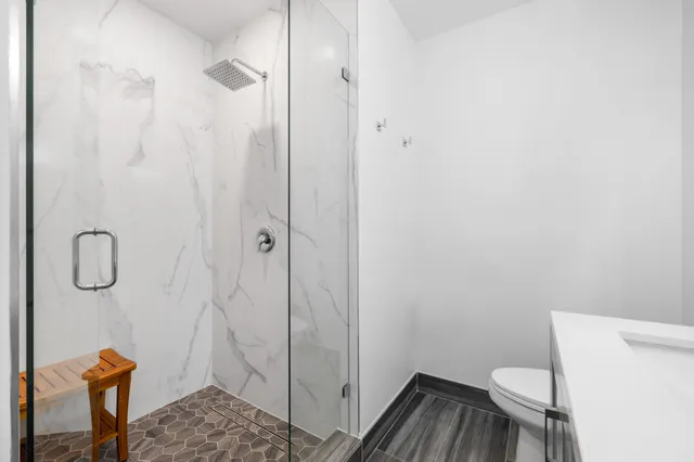 a bathroom with a toilet and a shower