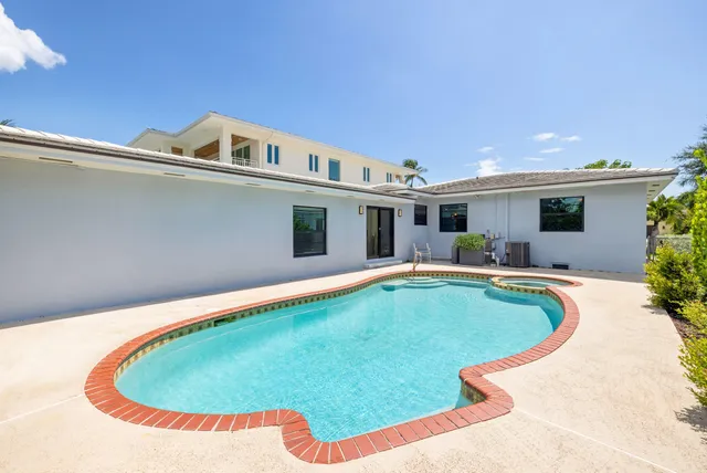 a view of a swimming pool with an outdoor seating