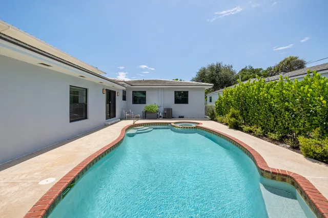 a swimming pool with outdoor seating and yard