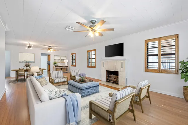 a living room with furniture a fireplace and a flat screen tv