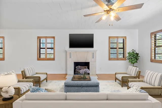 a living room with furniture a fireplace and a flat screen tv