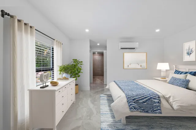 a spacious bedroom with a large bed and a window