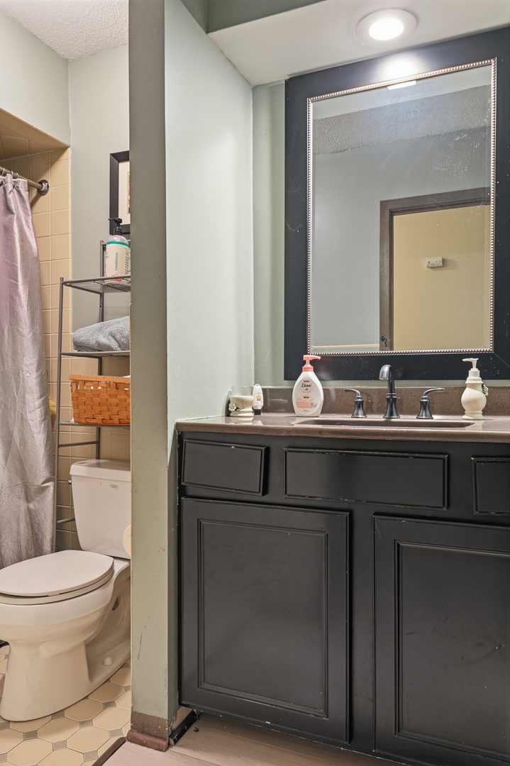 3623 34th Street Moline, IL 61265 - Photo 16 of 22 a bathroom with a granite countertop sink a toilet and a mirror
