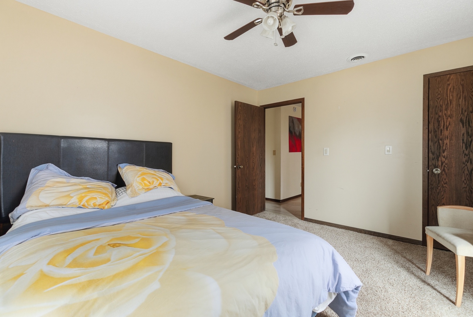 3623 34th Street Moline, IL 61265 - Photo 3 of 22 a bedroom with a bed and a chandelier