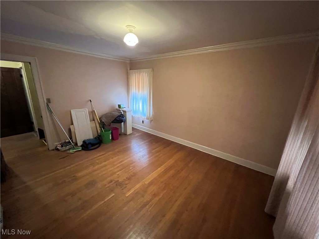 4581 Pearl Road Cleveland, OH 44109 - Photo 23 of 36 Unfurnished room featuring crown molding and wood finished floors
