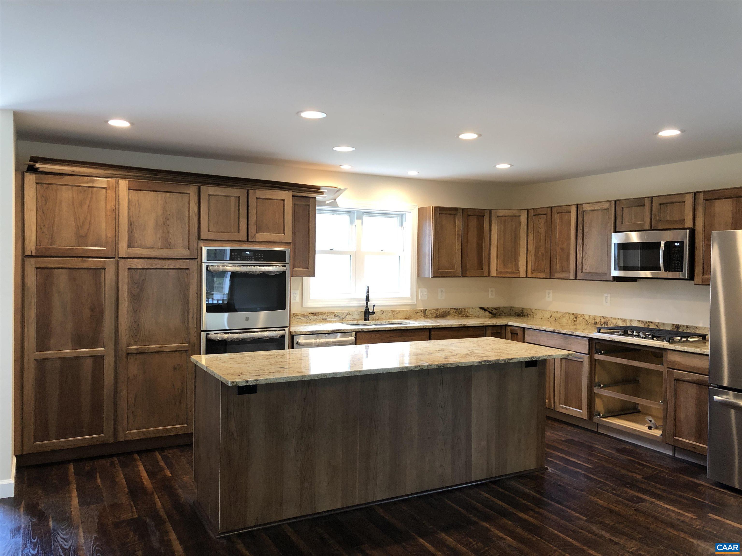2150 C Moore Road, Unit LOT 7 Ruckersville, VA 22968 - Photo 6 of 7 a large kitchen with stainless steel appliances granite countertop a stove a sink and a refrigerator