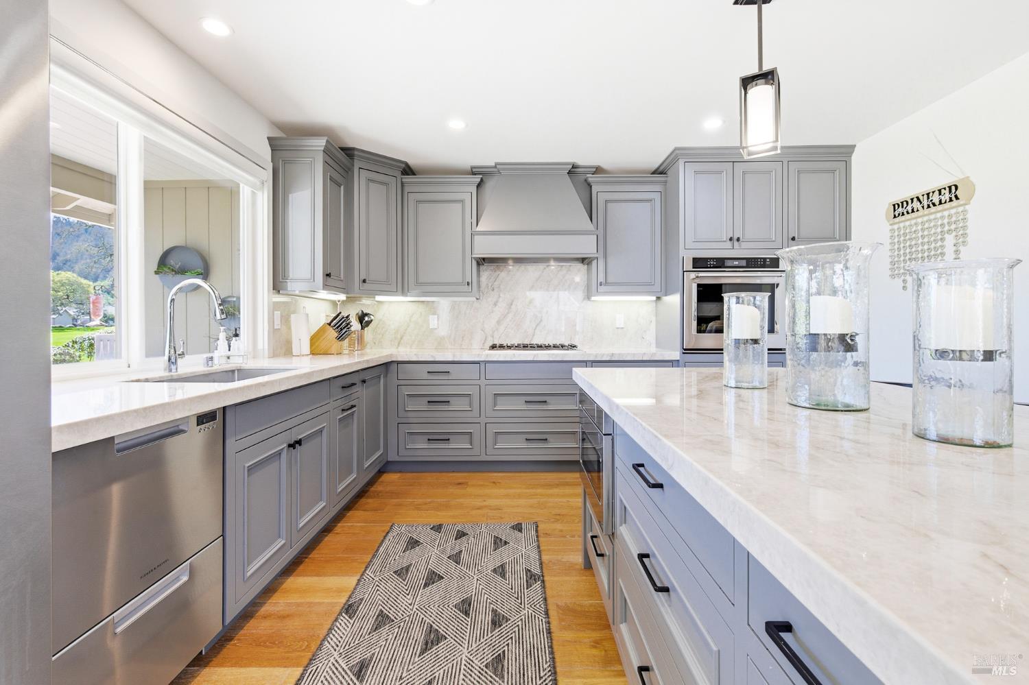 334 Miramonte Way Santa Rosa, CA 95409 - Photo 12 of 46 a kitchen with kitchen island granite countertop a sink stove and cabinets