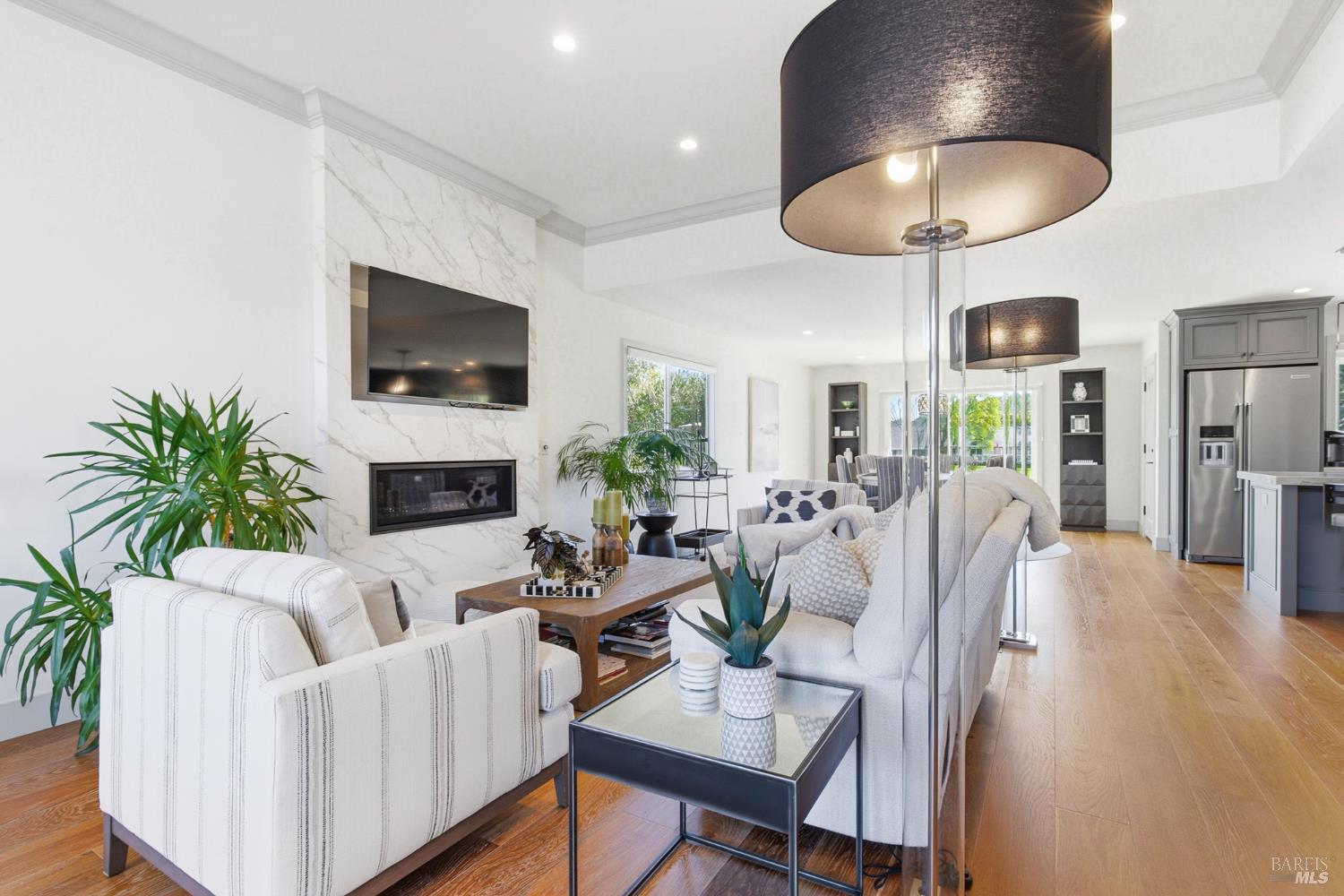 334 Miramonte Way Santa Rosa, CA 95409 - Photo 4 of 46 a living room with furniture a flat screen tv and a fireplace