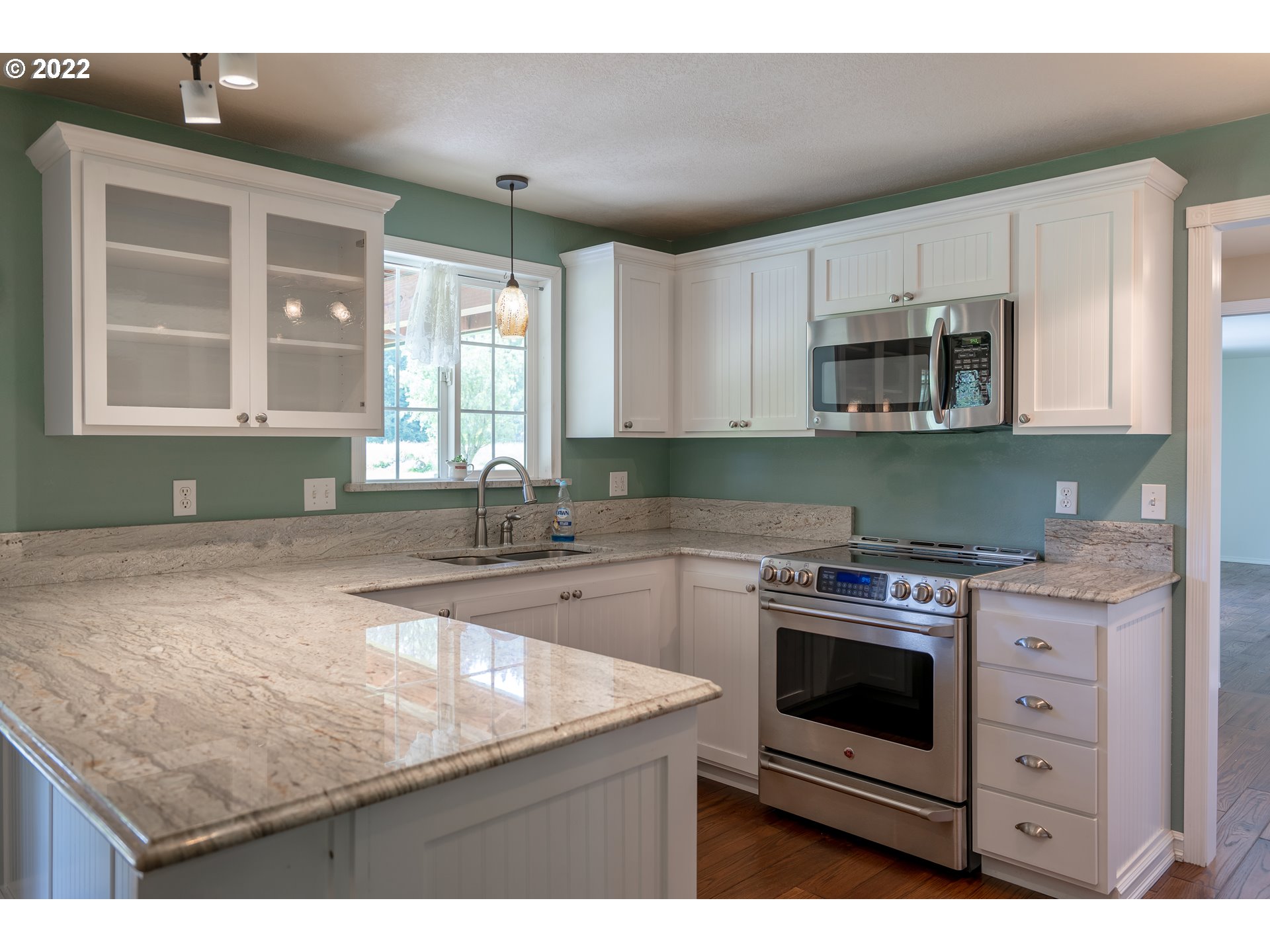 87817 Cedar Flat Road Springfield, OR 97478 - Photo 5 of 32 a kitchen with stainless steel appliances granite countertop a stove a sink and a microwave