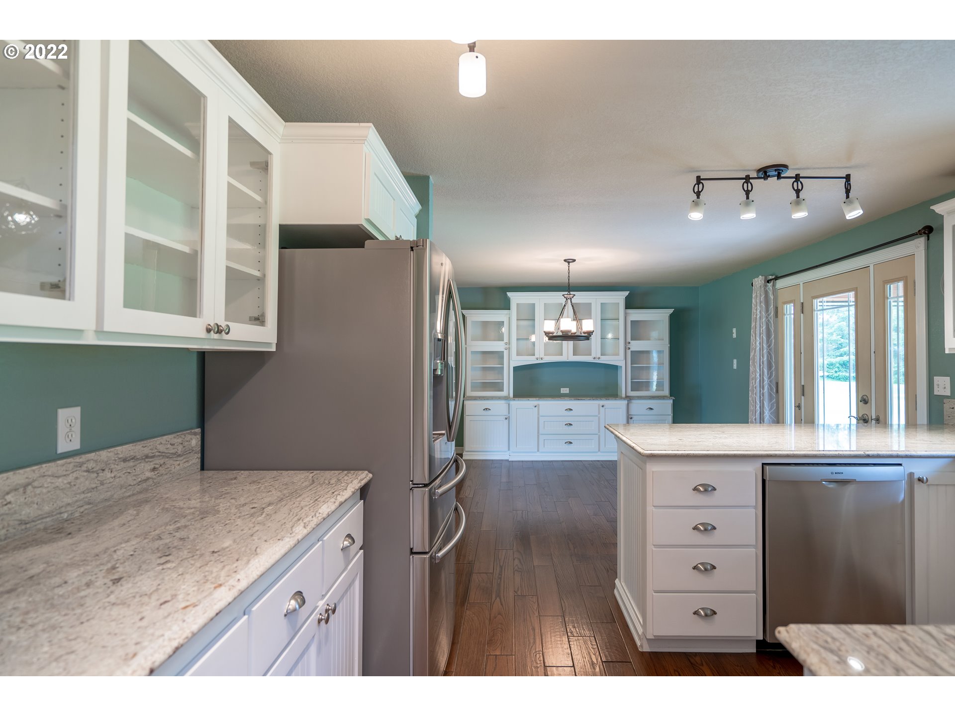 87817 Cedar Flat Road Springfield, OR 97478 - Photo 8 of 32 a kitchen with a wooden floor and cabinets