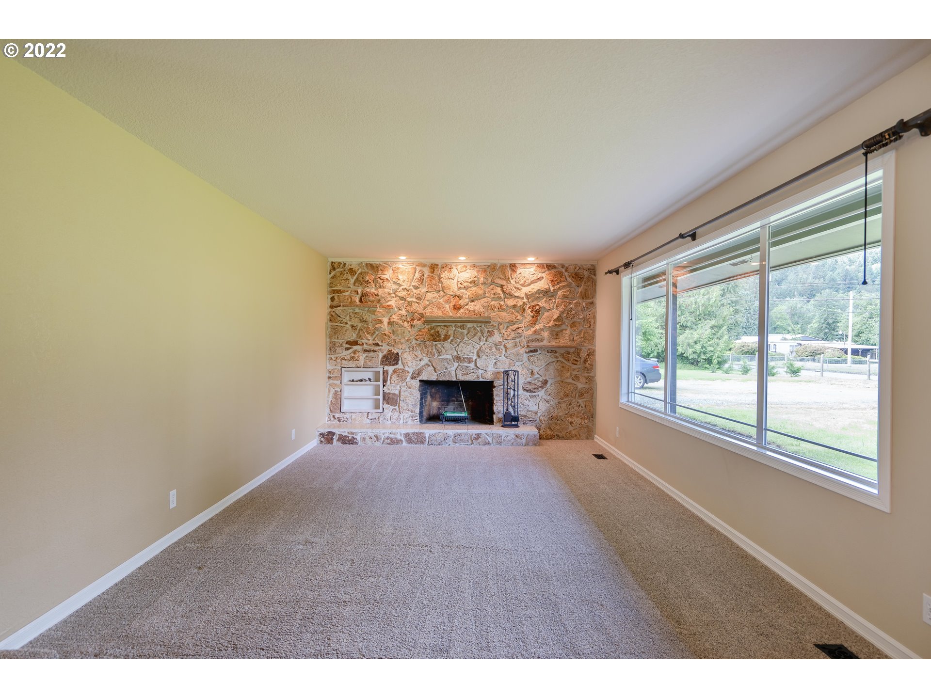 87817 Cedar Flat Road Springfield, OR 97478 - Photo 9 of 32 a view of an empty room with a fireplace and a window