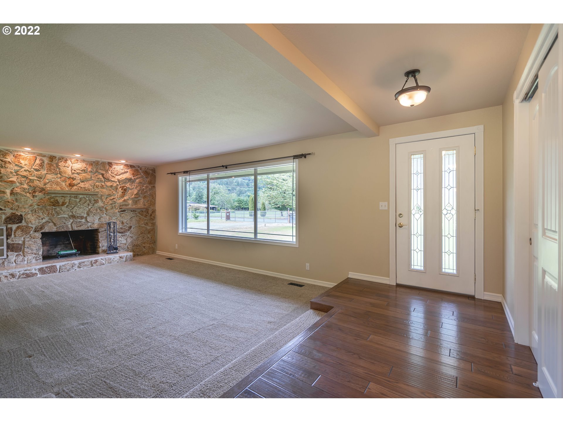 87817 Cedar Flat Road Springfield, OR 97478 - Photo 10 of 32 a view of an empty room with a window and fireplace
