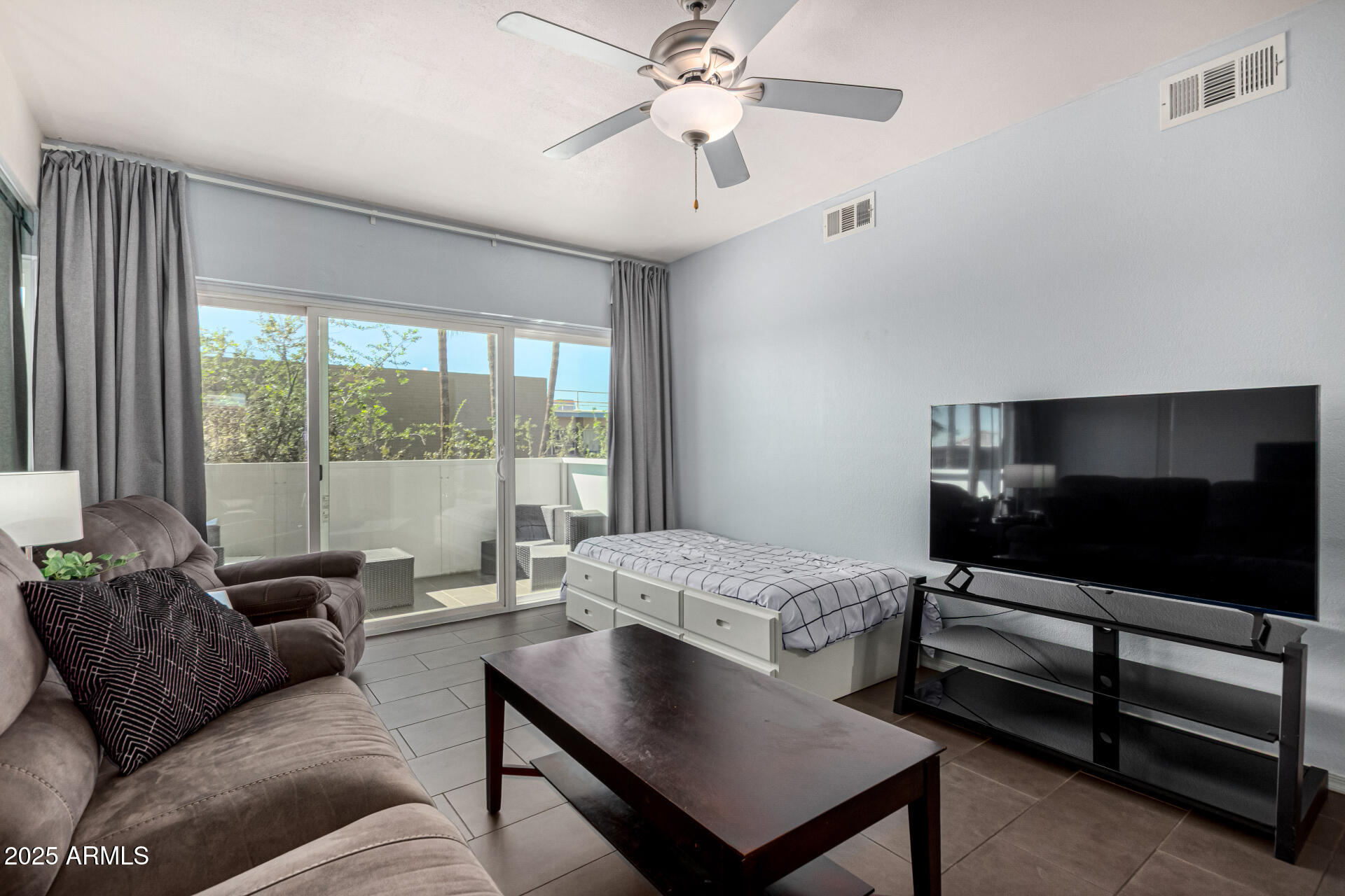 351 East Thomas Road, Unit D505 Phoenix, AZ 85012 - Photo 11 of 28 a living room with furniture and a flat screen tv