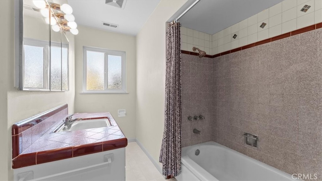 3658 Rodgers Avenue Chico, CA 95928 - Photo 24 of 52 a bathroom with a tub sink vanity and mirror