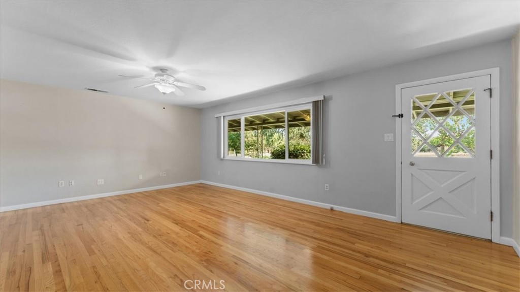 3658 Rodgers Avenue Chico, CA 95928 - Photo 7 of 52 an empty room with wooden floor chandelier fan and windows