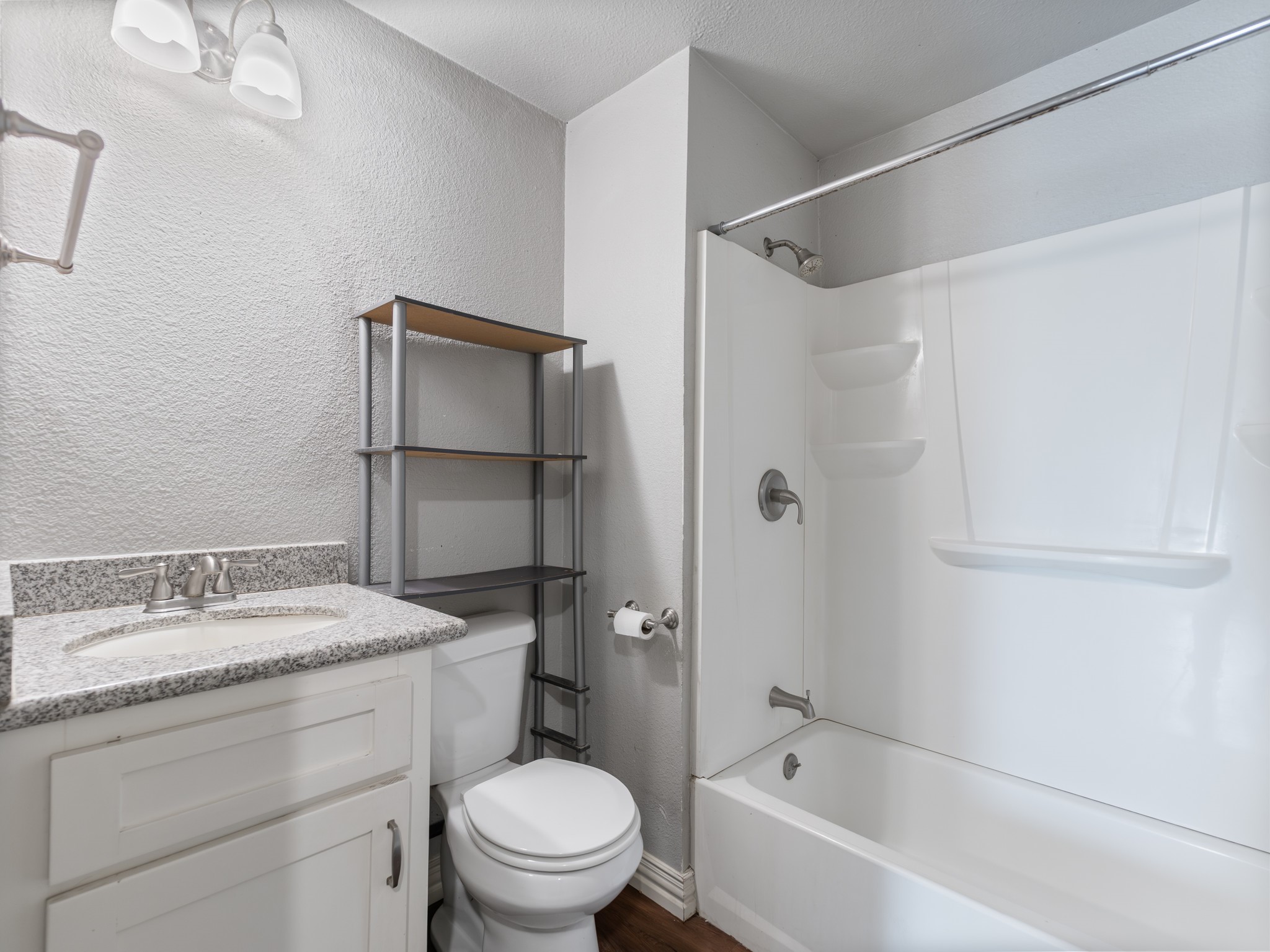 1921 Foote Street Wharton, TX 77488 - Photo 10 of 18 a bathroom with a granite countertop sink toilet and shower