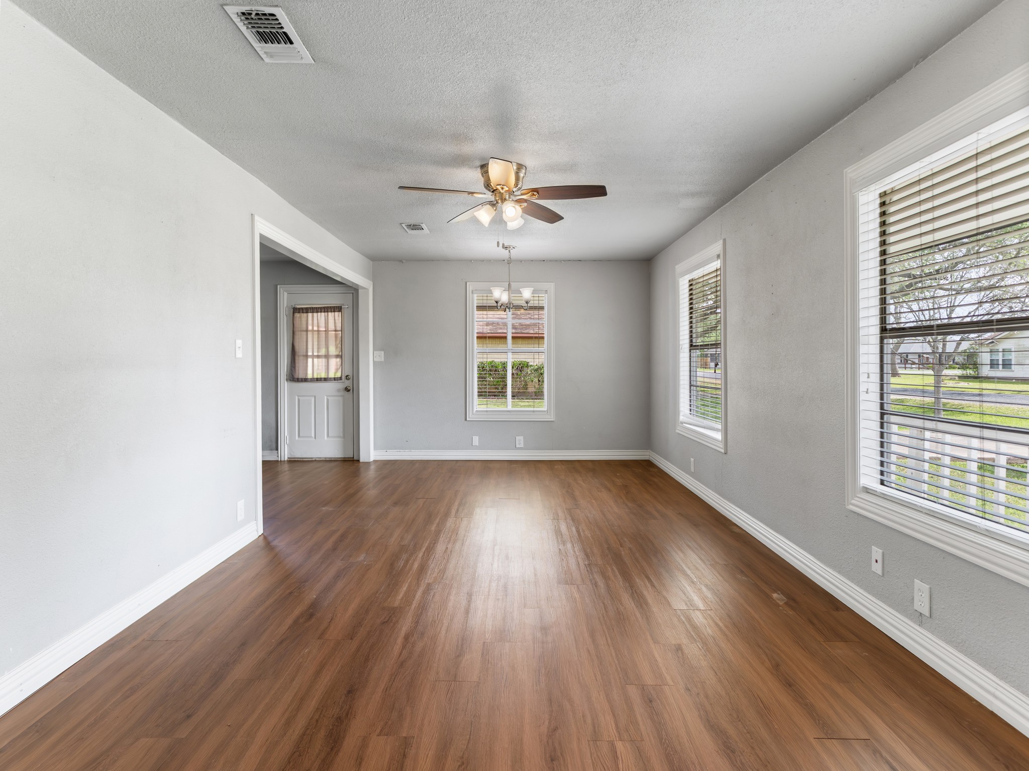 1921 Foote Street Wharton, TX 77488 - Photo 4 of 18 a view of an empty room with wooden floor and a window