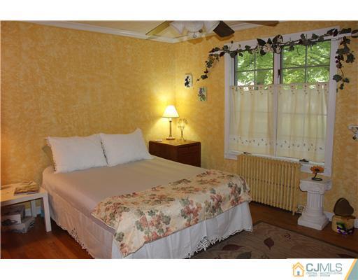24 Old Post Road Edison, NJ 08817 - Photo 7 of 22 a bedroom with a bed and a painting on the wall