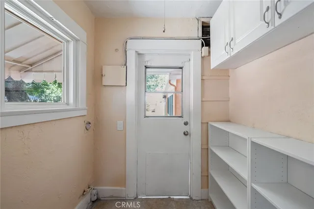 a view of room with window and hallway