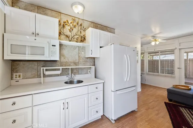 a kitchen with stainless steel appliances a refrigerator sink and cabinets