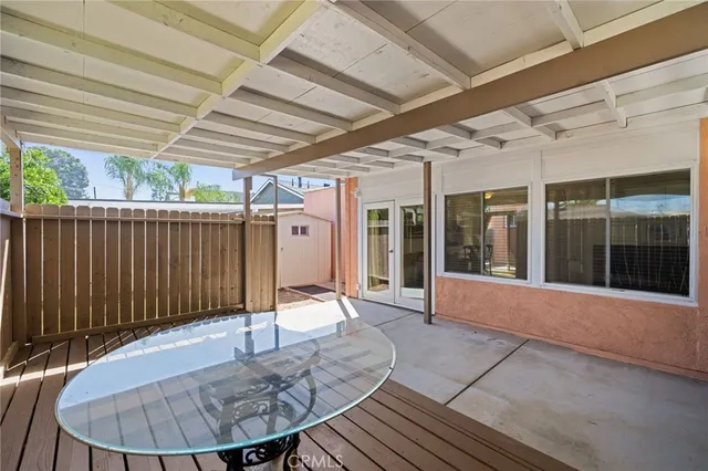 a view of a porch with a table and chairs