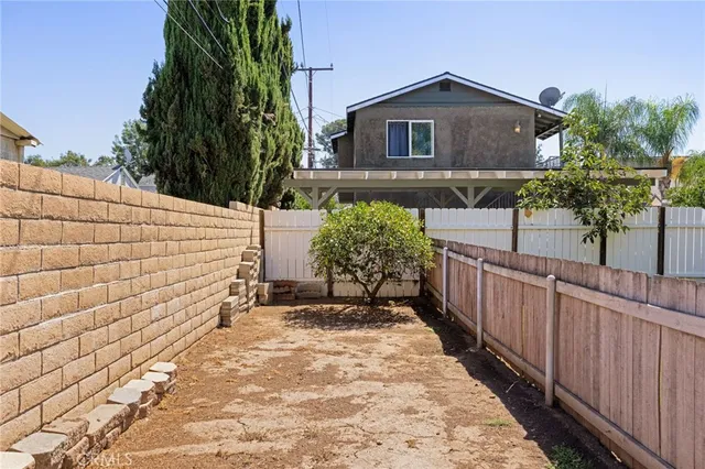 a front view of a house with wooden fence
