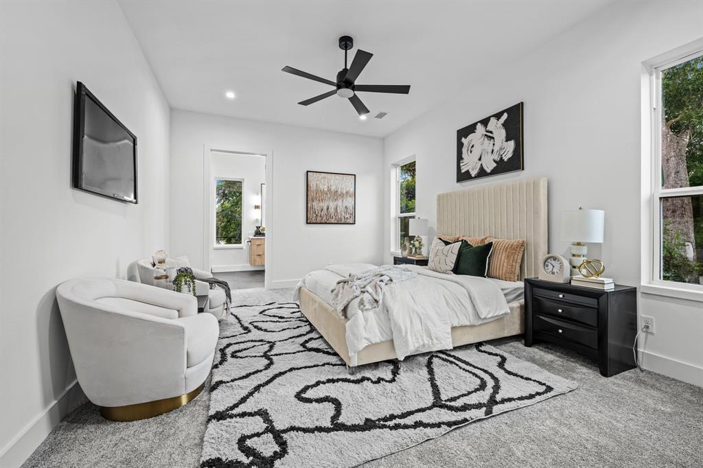 812 West 10th Street Dallas, TX 75208 - Photo 13 of 27 a bed room with a bed and a chandelier