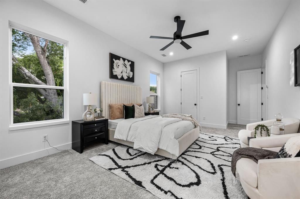 812 West 10th Street Dallas, TX 75208 - Photo 14 of 27 a spacious bedroom with a bed a couch and a window
