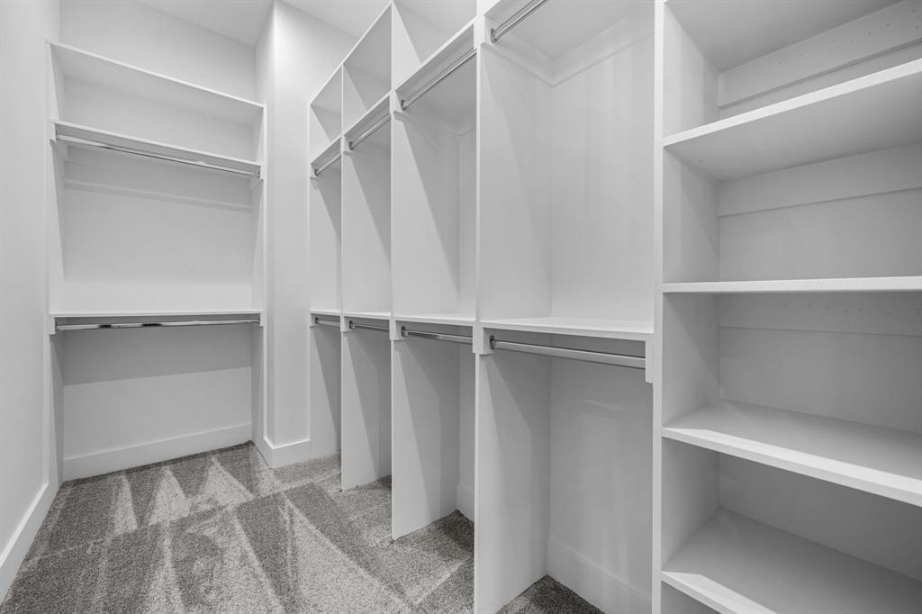 812 West 10th Street Dallas, TX 75208 - Photo 17 of 27 a view of walk in closet with empty racks