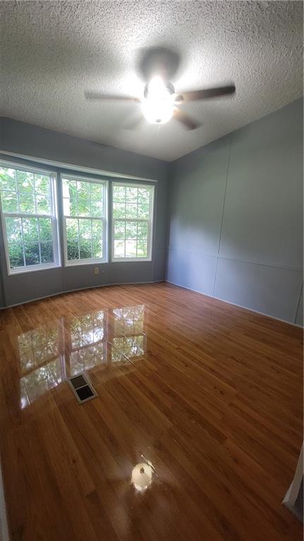 174 Luther Circle Villa Rica, GA 30180 - Photo 12 of 32 a view of empty room with wooden floor and fan