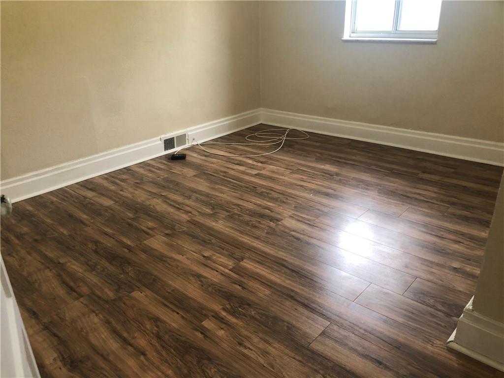 1141 9th Street McKees Rocks, PA 15136 - Photo 14 of 21 a room with wooden floor and windows