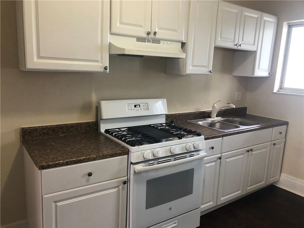1141 9th Street McKees Rocks, PA 15136 - Photo 7 of 21 a white stove top oven sitting inside of a kitchen