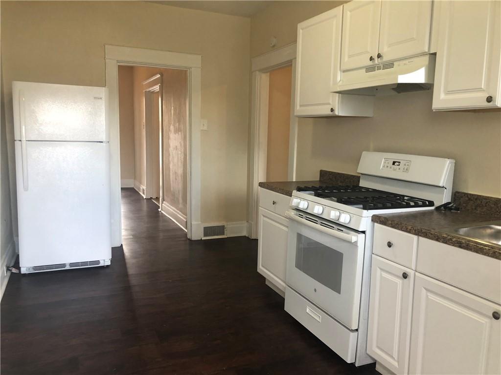 1141 9th Street McKees Rocks, PA 15136 - Photo 8 of 21 a kitchen with granite countertop white cabinets and white appliances