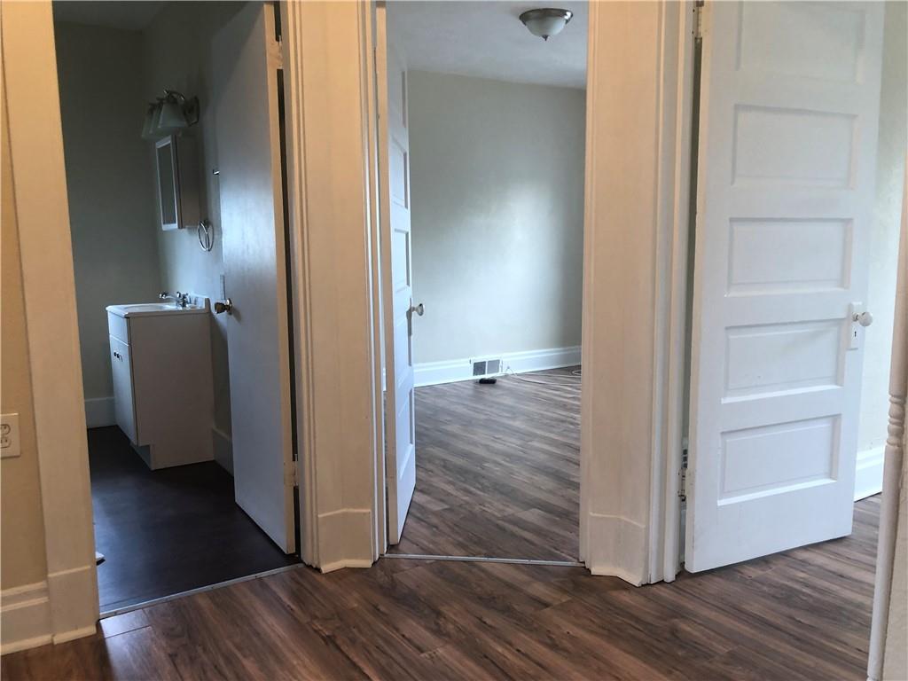 1141 9th Street McKees Rocks, PA 15136 - Photo 10 of 21 a view of a hallway with wooden floor and closet